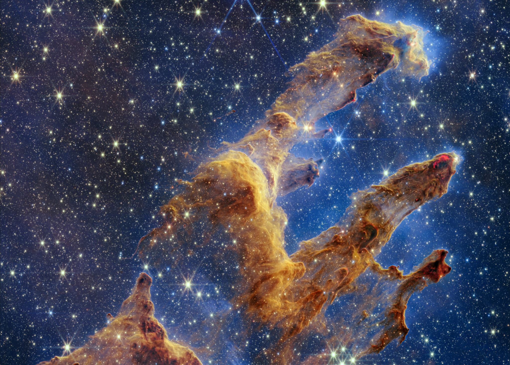 The Pillars of Creation: towers of golden gas and dust.