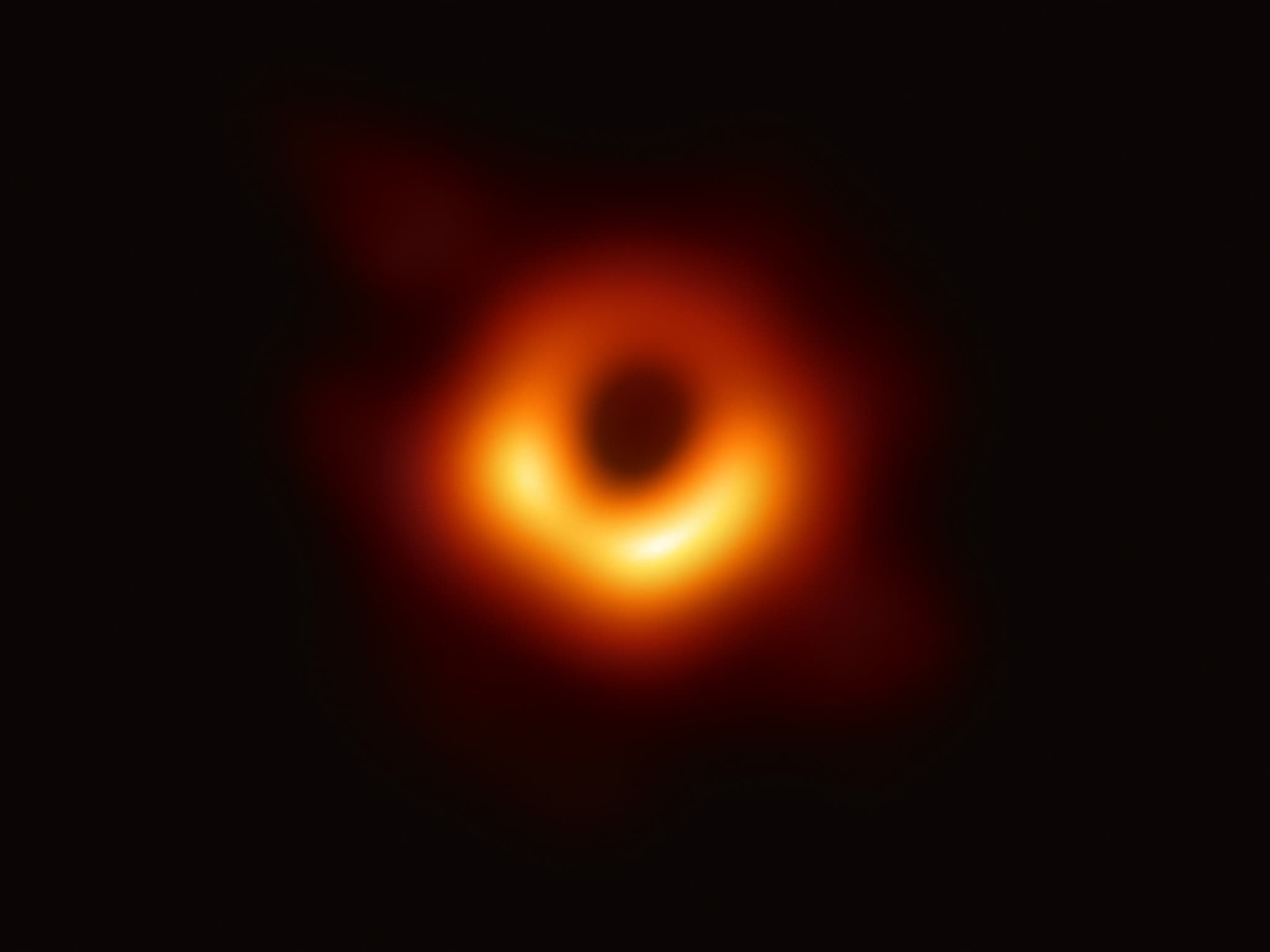 The first image of a black hole: a glowing orange ring around the dark shadow of M87*.