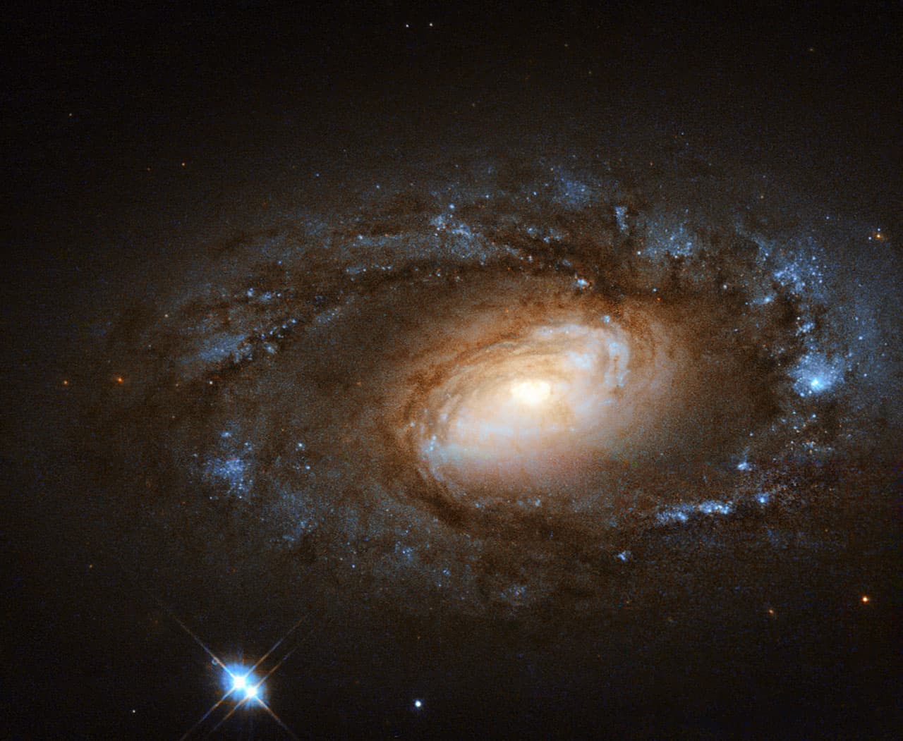 Spiral galaxy NGC 4102 with a glowing golden core.